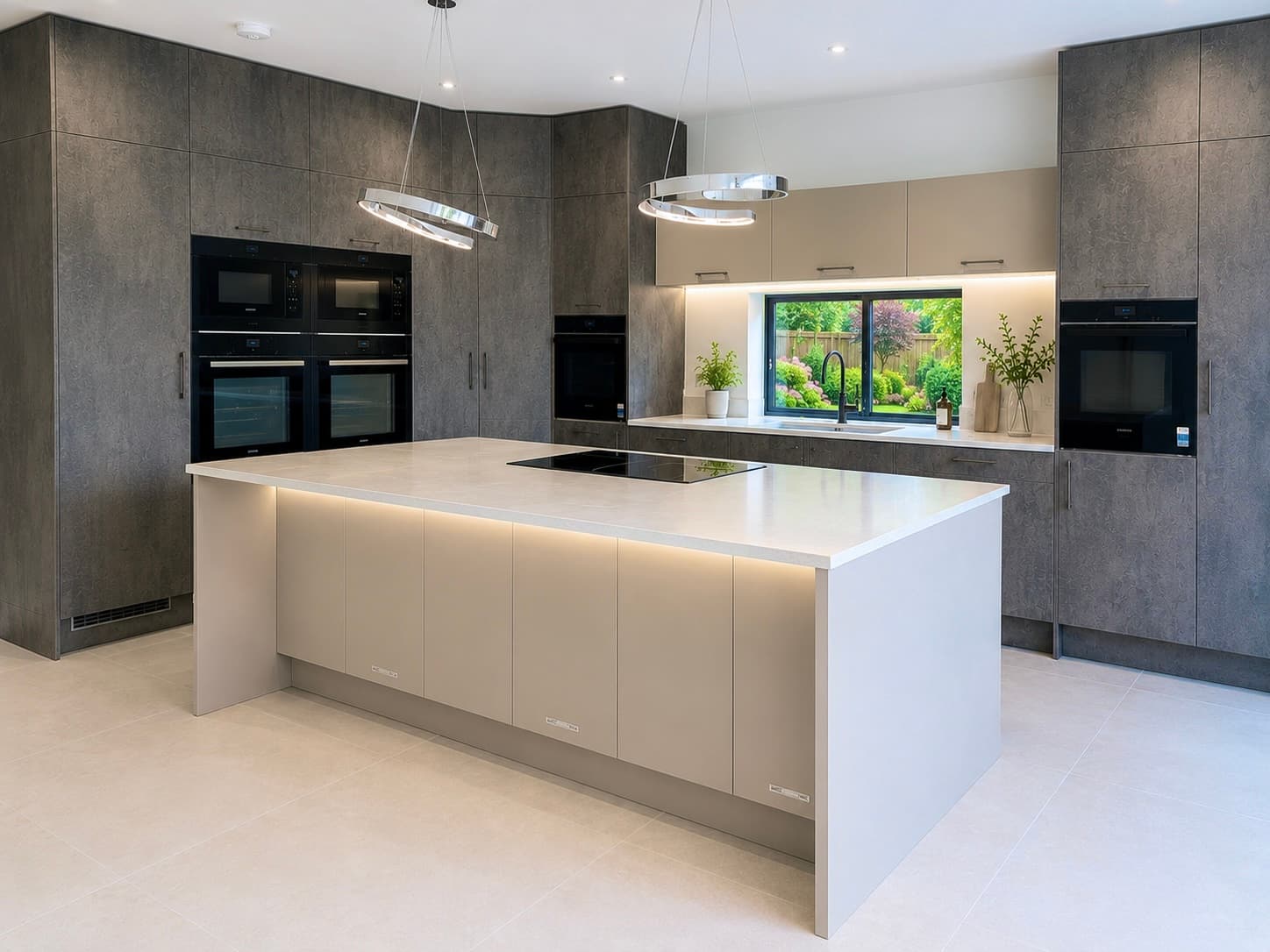 Handleless kitchen with stone-effect tall units and a taupe island in Mill Hill